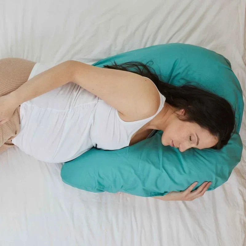 Pregnant woman lying on her side on the TheraMed Side Snuggler