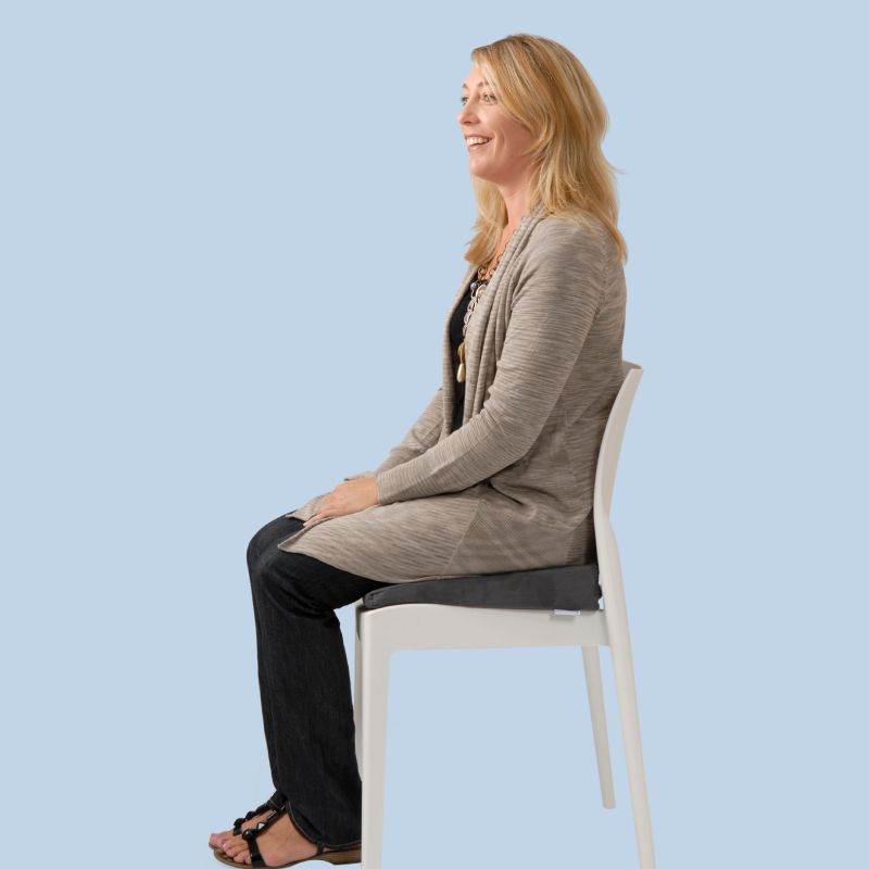 Woman sitting on the TheraMed Coccyx Tailbone Wedge