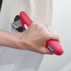 Hand gripping the Handybar fitted to a car door frame