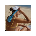 Woman at the beach reaching over her shoulder with the BakSlap Lotion Applicator