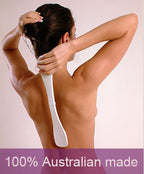 Woman applying lotion to her back with the Easy-Reach Lotion Applicator