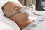 Man asleep wearing the Fisher and Paykel Pilairo Q Pillow Mask