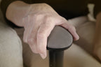 Hand resting on the Independence Tray Table padded support handle
